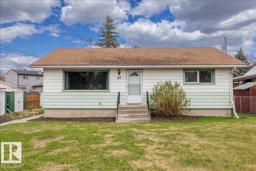 Single-story residence featuring white and light green horizontal siding and a brown shingle roof - 24 Elizabeth Drive, Fort Saskatchewan, AB - Outdoor