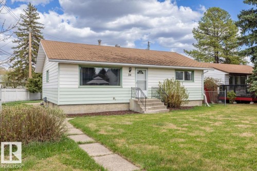 Bungalow residence featuring a brown shingle roof and light-colored siding - 24 Elizabeth Drive, Fort Saskatchewan, AB - Outdoor