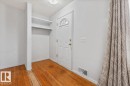 Entryway featuring a white paneled door with a half-moon glass insert, brass hardware, and wood-finish flooring - 24 Elizabeth Drive, Fort Saskatchewan, AB  - Indoor Photo Showing Other Room 