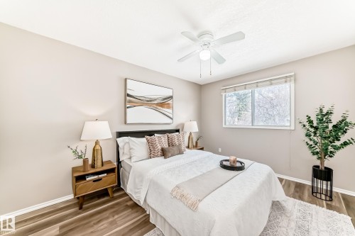 Bedroom featuring a window with a view of trees, a ceiling fan, and wood-style flooring - 10329 150 Street, Edmonton, AB - Indoor Photo Showing Bedroom