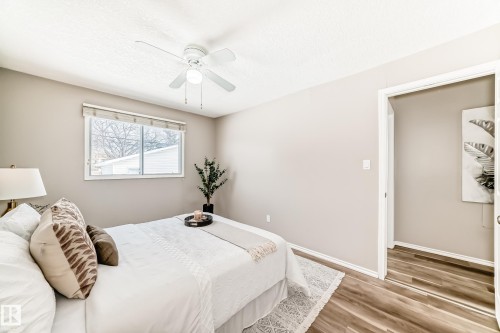 This room features a window providing natural light, a ceiling fan, and light-toned walls - 10329 150 Street, Edmonton, AB - Indoor Photo Showing Bedroom
