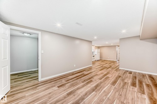 This space features wood-style flooring and recessed lighting, offering an inviting atmosphere - 10329 150 Street, Edmonton, AB - Indoor