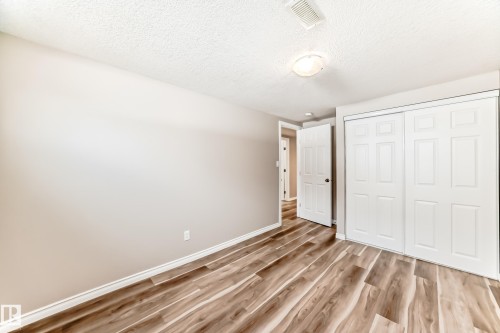 This room features light-colored walls and wood-look flooring - 10329 150 Street, Edmonton, AB - Indoor Photo Showing Other Room