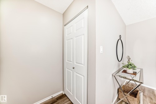 Entryway featuring light-toned walls, a white bi-fold closet door, and wood-look flooring - 10329 150 Street, Edmonton, AB - Indoor Photo Showing Other Room
