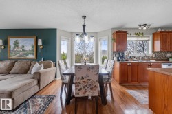 Open-concept living space featuring wood-finish flooring throughout - 