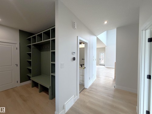 Built-in green mudroom storage with bench seating and shelving - 202 Edgewater Circle, Leduc, AB - Indoor Photo Showing Other Room