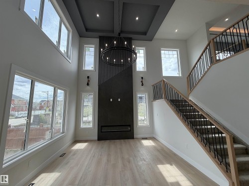 Two-story ceiling with recessed lighting and a decorative chandelier - 202 Edgewater Circle, Leduc, AB - Indoor Photo Showing Other Room
