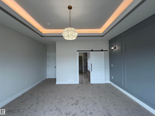 Tray ceiling with accent lighting - 202 Edgewater Circle, Leduc, AB - Indoor Photo Showing Other Room
