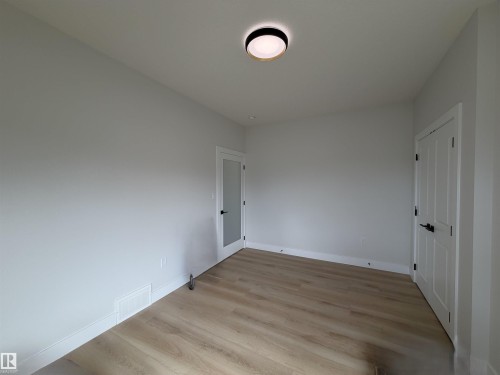 Room featuring light-toned walls and wood-finish flooring - 202 Edgewater Circle, Leduc, AB - Indoor Photo Showing Other Room
