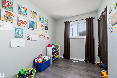 Interior room featuring a single window, recessed closet, and wood-finish flooring - 17 Camelot Avenue, Leduc, AB - Indoor