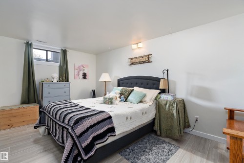 Bedroom featuring light wood-finish flooring, white walls, and a window with a deep sill - 17 Camelot Avenue, Leduc, AB - Indoor Photo Showing Bedroom