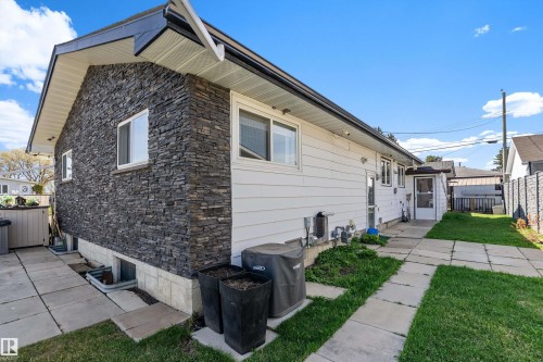 Exterior featuring stone veneer siding and white horizontal siding - 17 Camelot Avenue, Leduc, AB - Outdoor With Exterior