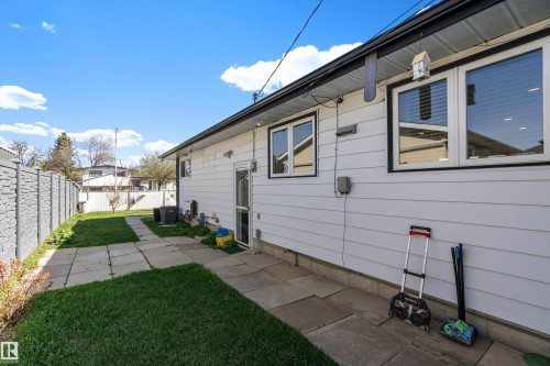Rear exterior featuring white horizontal siding and a black trim roofline - 17 Camelot Avenue, Leduc, AB - Outdoor With Exterior
