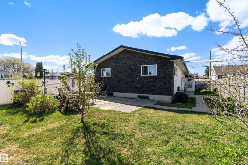 Exterior featuring dark brick siding and white window frames - 17 Camelot Avenue, Leduc, AB - Outdoor