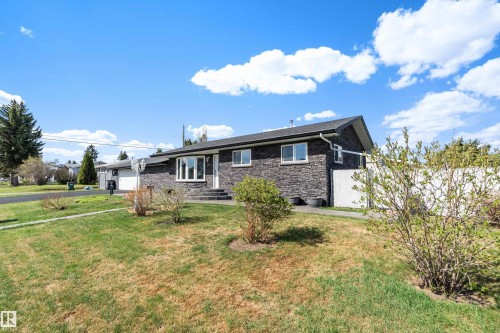 Ranch-style residence featuring a prominent stone facade and white trim - 17 Camelot Avenue, Leduc, AB - Outdoor