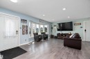 Spacious living area featuring wood-finish flooring, recessed lighting, and a prominent bay window - 17 Camelot Avenue, Leduc, AB  - Indoor Photo Showing Living Room 