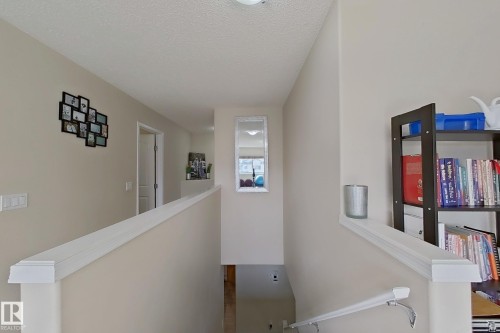 The property features a staircase with a white handrail and light-colored walls - 3120 25 Avenue Nw, Edmonton, AB - Indoor