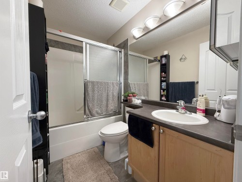 Bathroom featuring a vanity with a sink, a large mirror, and overhead lighting - 3120 25 Avenue Nw, Edmonton, AB - Indoor Photo Showing Bathroom