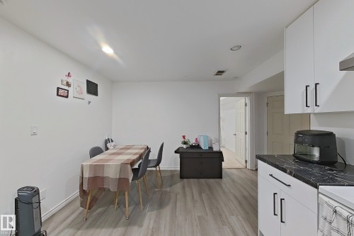 This open-concept area features light-colored flooring, white walls, and recessed lighting - 3120 25 Avenue Nw, Edmonton, AB - Indoor Photo Showing Kitchen
