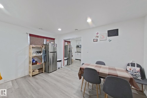 This bright living space features light-toned flooring, white walls, and recessed lighting - 3120 25 Avenue Nw, Edmonton, AB - Indoor Photo Showing Dining Room
