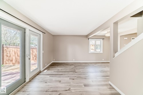 Spacious living area featuring wood-finish flooring, neutral wall tones, and white trim - 2578 138A Avenue, Edmonton, AB - Indoor Photo Showing Other Room