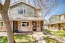 Two-story residence featuring a covered front porch with lattice detailing, stucco and siding exterior, and a central entryway with a dark-framed door - 2578 138A Avenue, Edmonton, AB  - Outdoor With Deck Patio Veranda 
