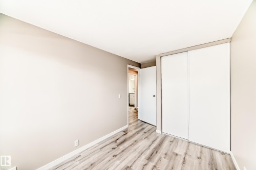 Room featuring wood-finish flooring, neutral wall tones, and white baseboards - 2578 138A Avenue, Edmonton, AB - Indoor Photo Showing Other Room