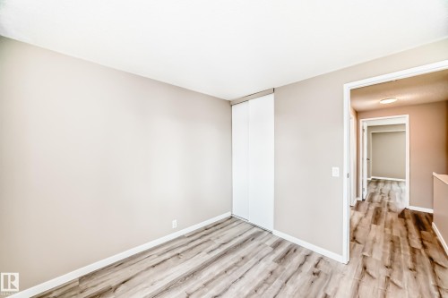 Room featuring wood-finish flooring, neutral wall tones, and white baseboards - 2578 138A Avenue, Edmonton, AB - Indoor Photo Showing Other Room