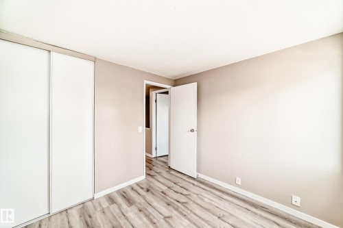 Room featuring wood-finish flooring, neutral wall tones, and white baseboards - 2578 138A Avenue, Edmonton, AB - Indoor Photo Showing Other Room