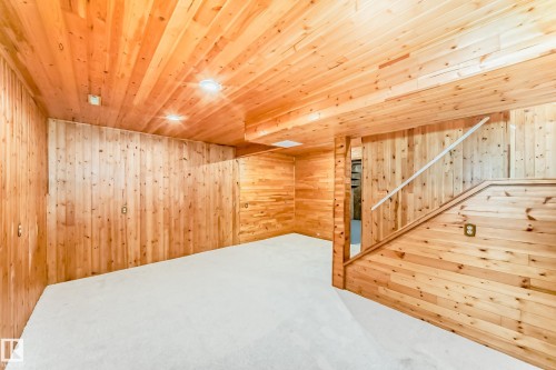 Room featuring extensive wood paneling, recessed lighting, and light-colored carpeting - 2578 138A Avenue, Edmonton, AB - Indoor Photo Showing Other Room