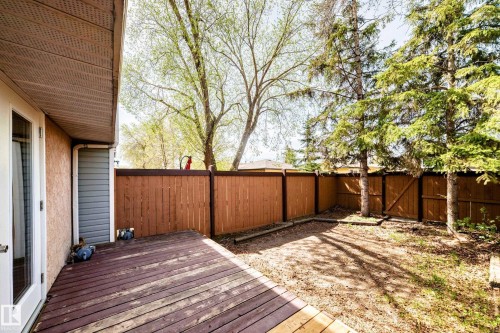Outdoor area featuring a wood deck, wood privacy fencing, and mature trees - 2578 138A Avenue, Edmonton, AB - Outdoor