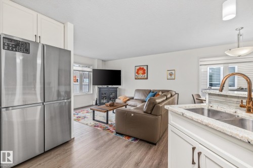 34 Red Tail Way, St. Albert, AB - Indoor Photo Showing Kitchen With Fireplace With Double Sink