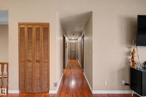 Hardwood-finish flooring extending through a central hallway with painted walls - 250 197 Avenue, Edmonton, AB - Indoor Photo Showing Other Room