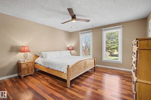 Spacious room featuring rich wood-finish flooring and neutral wall tones - 250 197 Avenue, Edmonton, AB - Indoor Photo Showing Bedroom