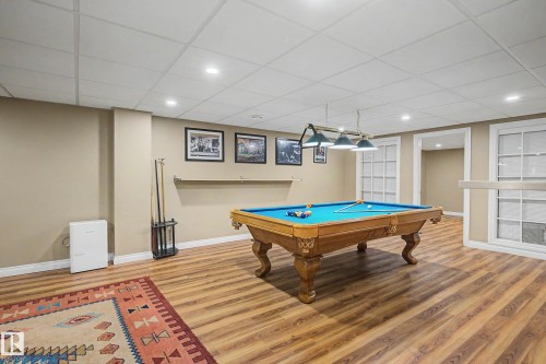 Recreation room featuring wood-finish flooring, recessed lighting, and a drop ceiling - 250 197 Avenue, Edmonton, AB - Indoor Photo Showing Other Room