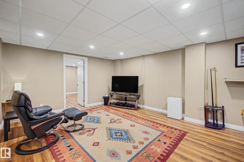Recreation room with wood-finish flooring, recessed lighting, and a neutral color palette - 250 197 Avenue, Edmonton, AB - Indoor Photo Showing Basement