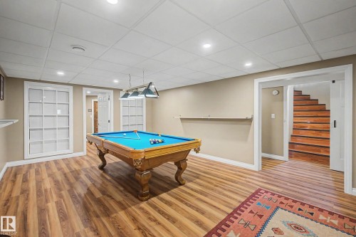 Spacious recreation room featuring wood-finish flooring and recessed lighting - 250 197 Avenue, Edmonton, AB - Indoor Photo Showing Other Room