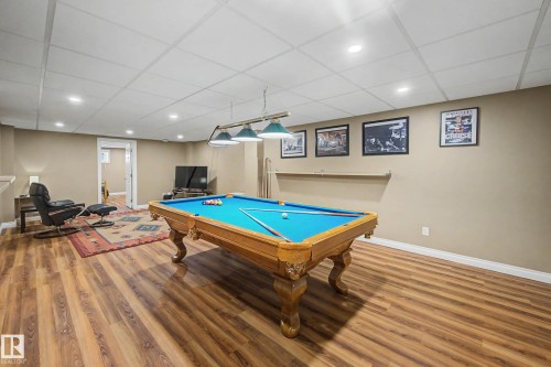 Spacious recreation area featuring wood-finish flooring, recessed lighting, and a drop ceiling - 250 197 Avenue, Edmonton, AB - Indoor Photo Showing Other Room