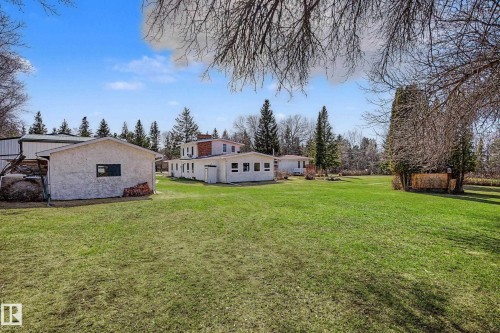 Expansive green lawn with scattered mature trees and a clear blue sky - 250 197 Avenue, Edmonton, AB - Outdoor