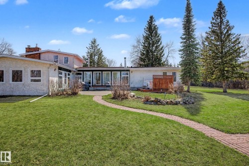 Expansive green lawn with a curved brick pathway leading to a rear patio - 250 197 Avenue, Edmonton, AB - Outdoor