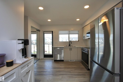 Kitchen with pantry, access to patio with retractable screen door. - 253 Marquis Boulevard, Edmonton, AB - Indoor Photo Showing Kitchen With Stainless Steel Kitchen