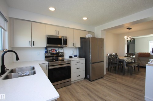 Kitchen is complete with stainless steel appliances & quartz counters. - 253 Marquis Boulevard, Edmonton, AB - Indoor Photo Showing Kitchen With Stainless Steel Kitchen With Double Sink
