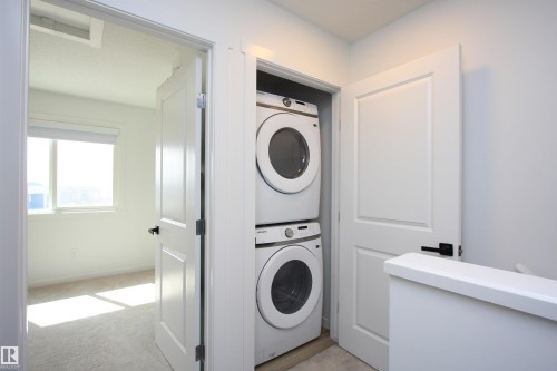 Convenient upper-floor laundry closet. - 253 Marquis Boulevard, Edmonton, AB - Indoor Photo Showing Laundry Room