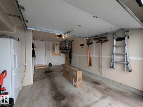 Attached garage with overhead storage rack. - 253 Marquis Boulevard, Edmonton, AB - Indoor Photo Showing Garage