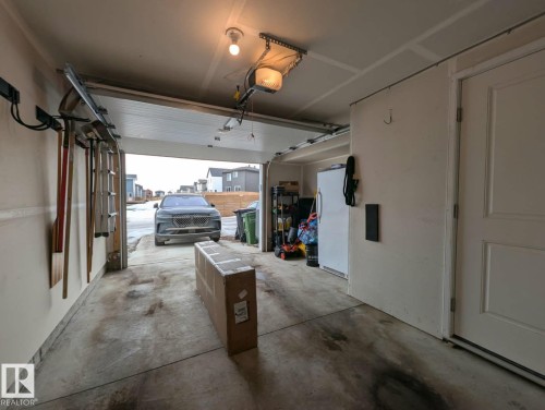 Single attached garage with storage and utility access. - 253 Marquis Boulevard, Edmonton, AB - Indoor Photo Showing Garage