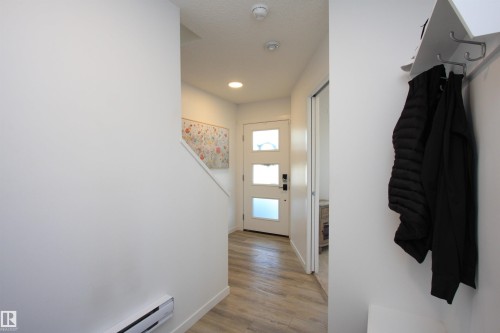 Entry from garage with convenient 1/2 bath to the right. - 253 Marquis Boulevard, Edmonton, AB - Indoor Photo Showing Other Room