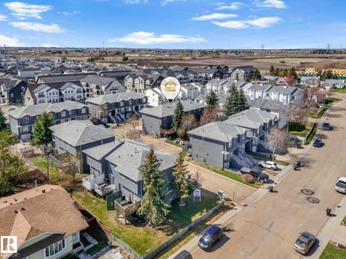 Multi-story residential community featuring individual units with private patios and balconies - 17 15128 22 Street, Edmonton, AB - Outdoor With View