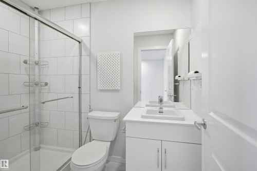 Bathroom featuring a glass-enclosed shower, a toilet, and a vanity with a sink and mirror - 2125 Maple Road Nw, Edmonton, AB - Indoor Photo Showing Bathroom