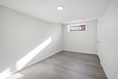 This room features light-colored walls and a window with blinds, allowing for natural light - 2125 Maple Road Nw, Edmonton, AB - Indoor Photo Showing Other Room