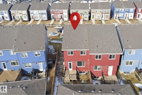 Aerial view of the property, showcasing the red exterior, multiple windows, and two decks - 2125 Maple Road Nw, Edmonton, AB - Outdoor